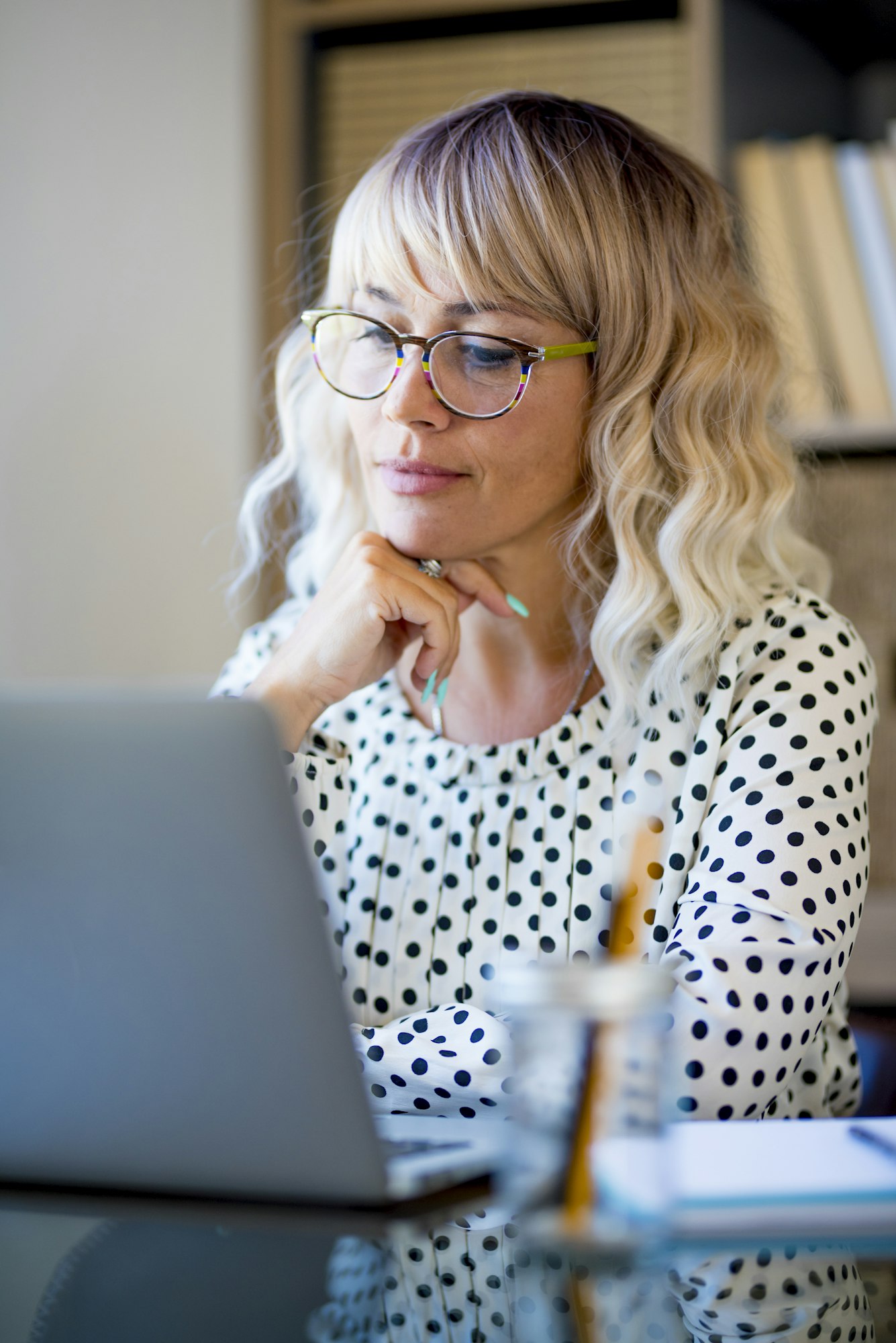 Businesswoman using laptop on desk. Confident young woman working on laptop at home office